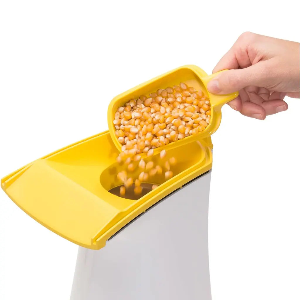 Air pop popcorn popper with kernels being poured into it.