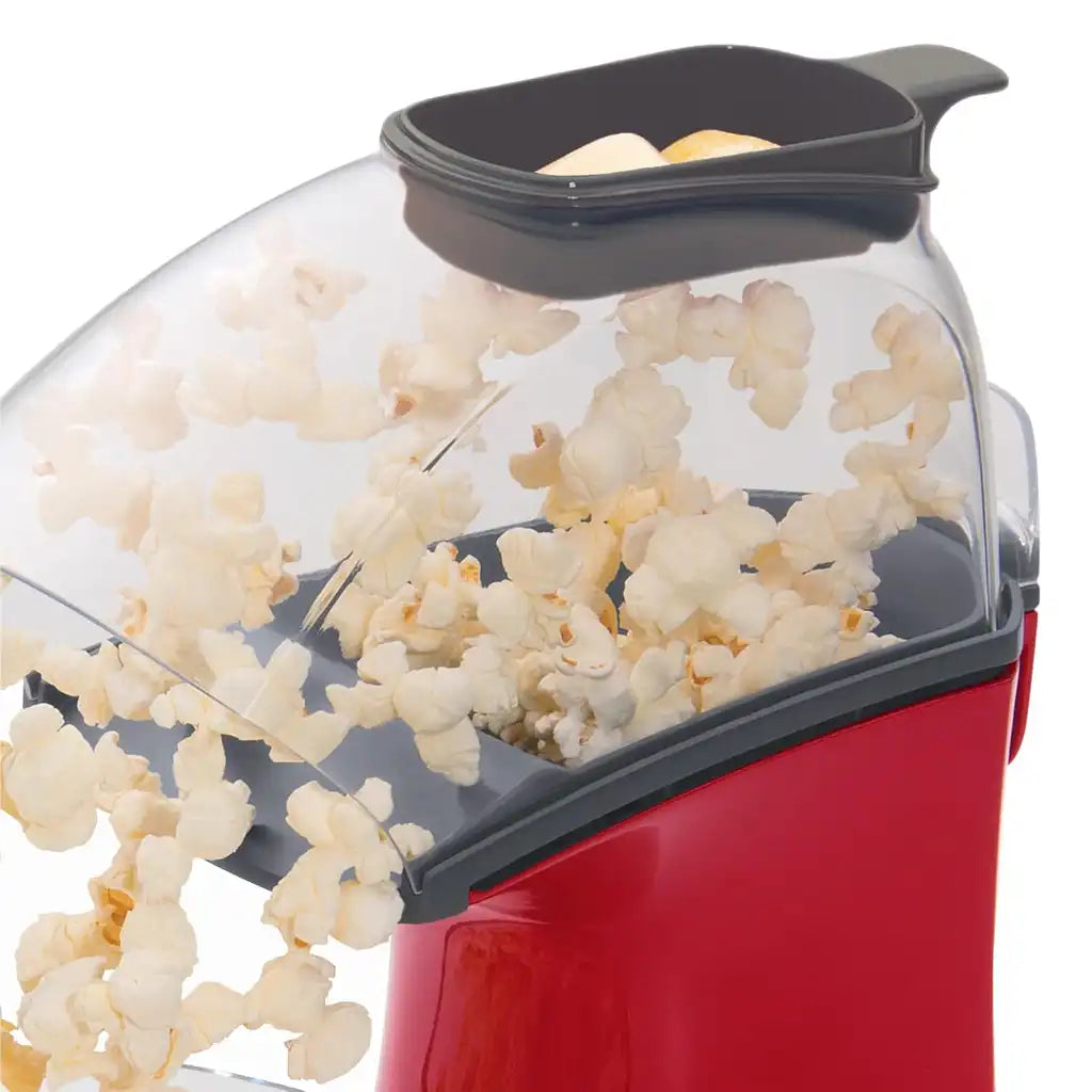 Red air pop popcorn popper with popped popcorn inside, top view.
