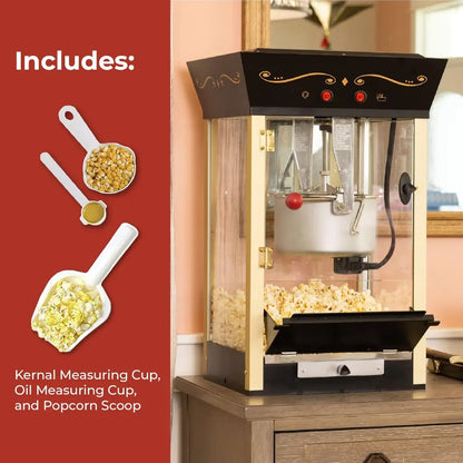 Black home movie theater popcorn machine with accessories on a wooden surface.