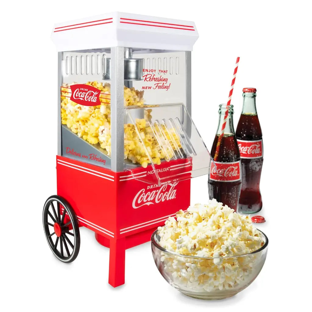 Coca-cola air pop popcorn machine with a bowl of popcorn and two coke bottles.