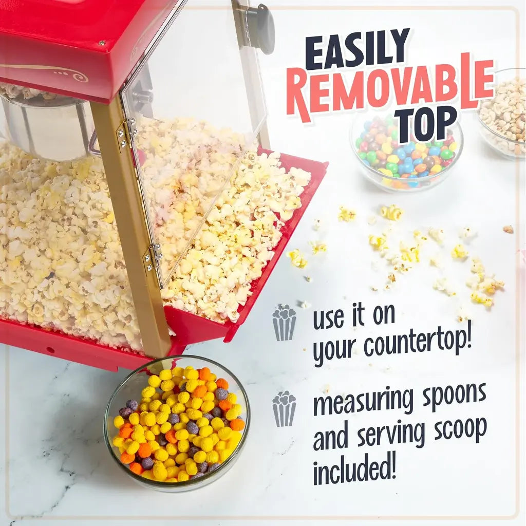 Home cinema popcorn machine with removable top on a countertop showing popcorn and candy.