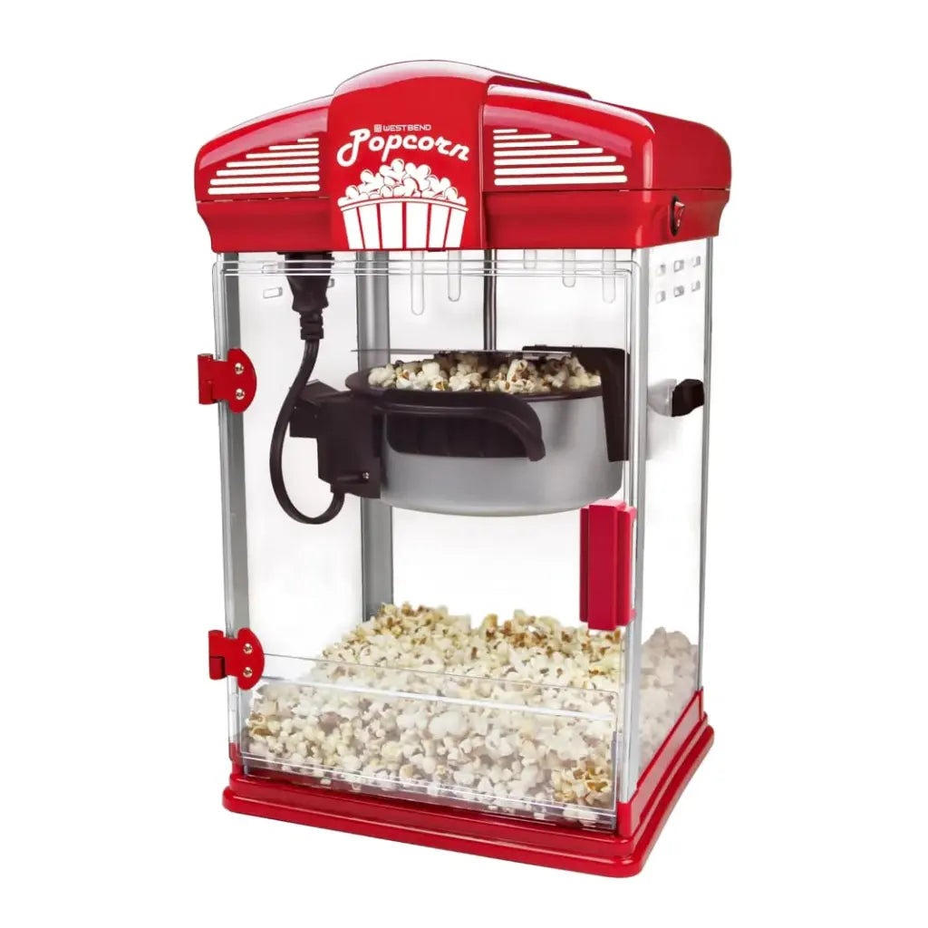 Popcorn popper machine with popped popcorn in kettle.