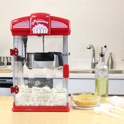 Popcorn popper machine on a kitchen counter with popped popcorn and kernels.
