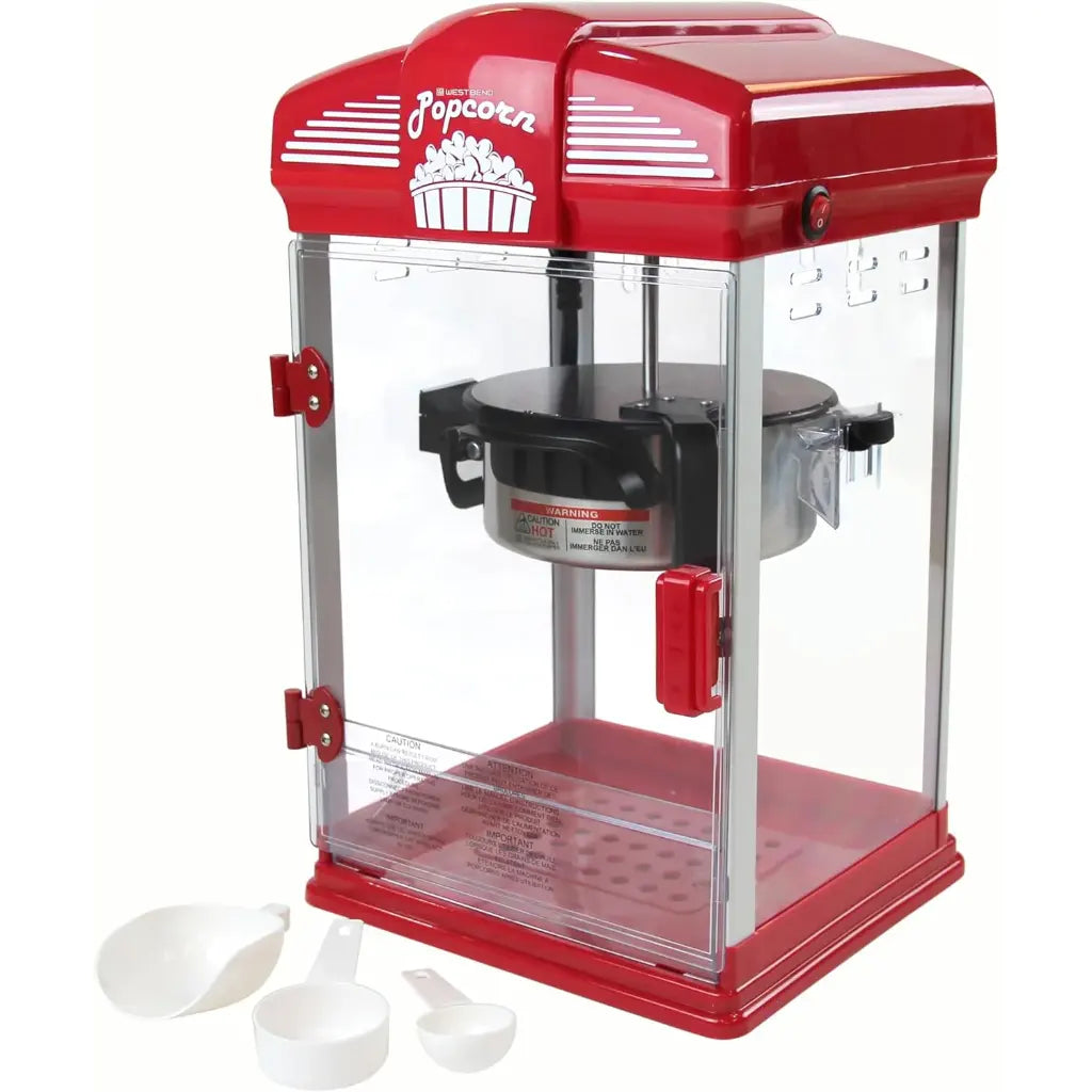 Popcorn popper machine with clear side panels and popcorn scoopers.
