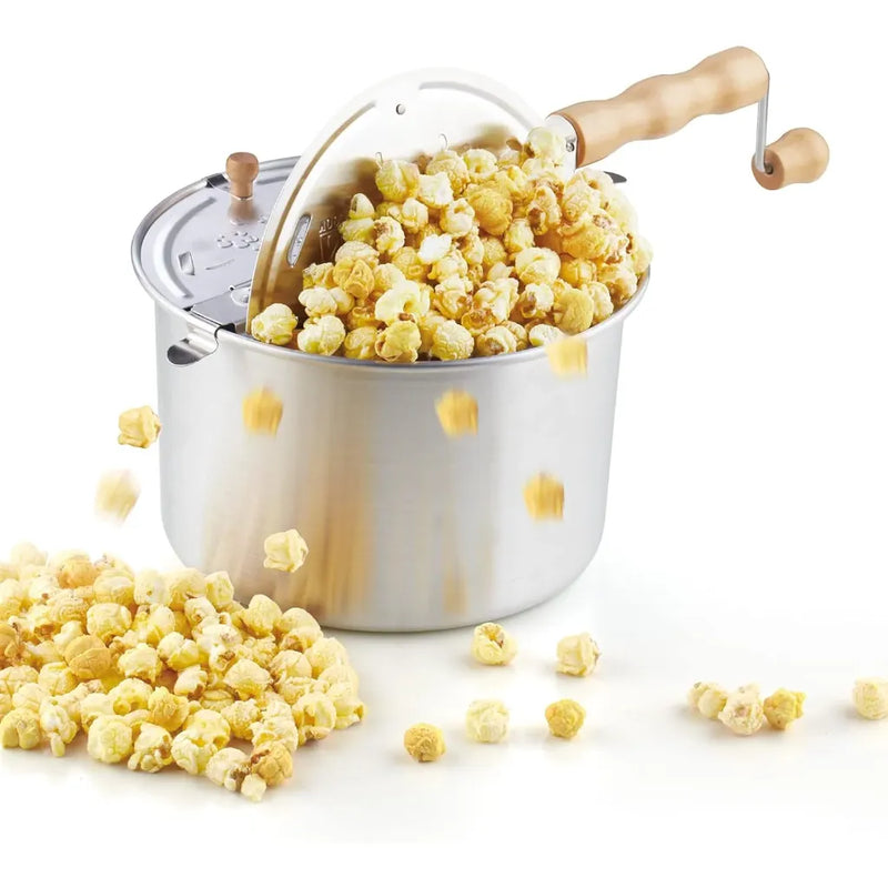 Stovetop popcorn popper with popped popcorn on a white background.