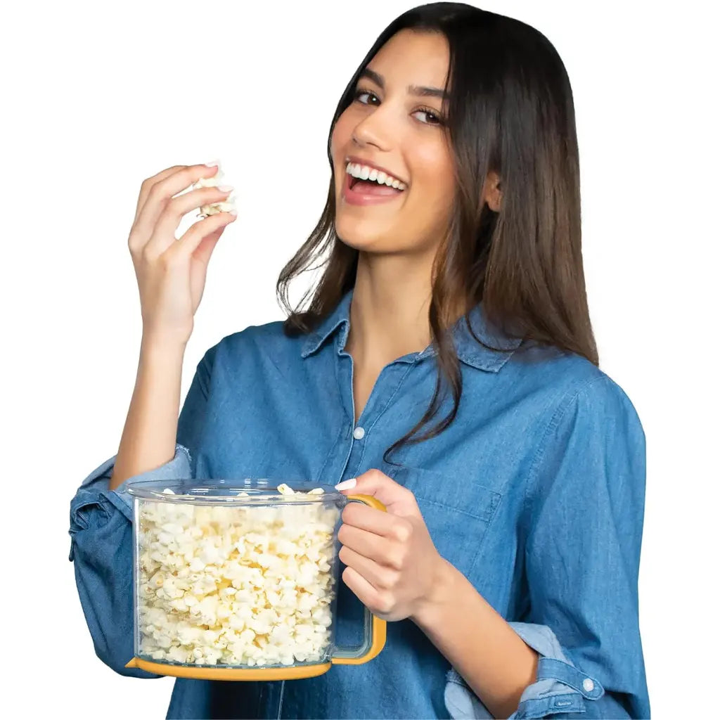 Woman holding the oil popcorn popper bowl filled with popcorn.